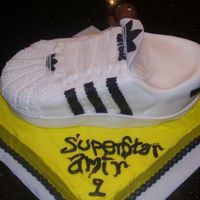 100_1082.jpg Adidas shell top SuperStar. Made for a friend who is obsessed with Adiadas. This was for his son's 1st birthday. Covered in fondant,...