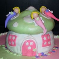 100_1213.jpg Fairy cake, got idea out of one of Debbi Browns cake decorating books. Marshmallow fondant, strawberry doctored cake creates pink inside....