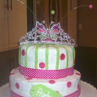 100_1105.jpg Butter cream covered cake with fondant accents, wire out of top with fondant balls covered in luster dust. Originally there was a RI tiara...