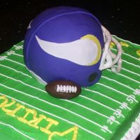 Copy_Of_100_0952.jpg 3D football Helmet cake using hand colored fondant, and butte cream covered football field.