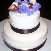 Copy_Of_100_0966.jpg Min wedding cake bottom is 6in, practice for the big day. Top is in butter cream and bottom is covered in white fondant, mis match done to...