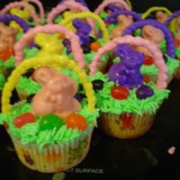 Easter Basket Cupcakes Easter Basket Cupcakes with buttercream frosting, jelly beans, and bunnies/handles made out of candy melts.