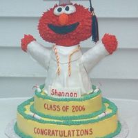 Graduation Elmo Elmo is sculpted from Rice Krispie treats and covered in fondant.