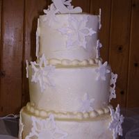 Snowflakes 6,8,10...buttercream with rasp. filling. Gumpaste snowflakes.