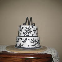 Black And White 2 Tier This is a 8 and 6 inch round chocolate cake with caramel filing and buttercream icing with fondant accents