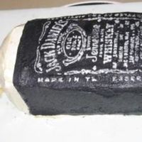 Jack Daniels' Cake This was a birthday cake for my sister who loves her JD. The cake is hand cut, and iced in buttercream. I printed a real JD label in mirror...