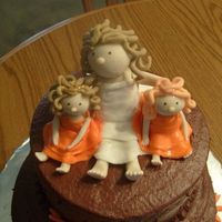 Bride And Flower Girls These figures were made out of gumpaste and put on top of a bridal shower cake. The bride has twin girls, one with red hair and one with...