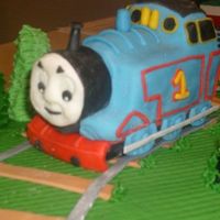 Thomas The Train Thomas was made for a 4th birthday. He was sculpted out of fondant that was dyed to the corresponding colors.