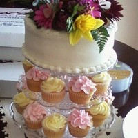 Small Cupcake Stand With A Small Cake On Top PINK AND YELLOW CUPCAKE AND A WHITE CAKE, WITH FRESH FLOWERS....THANKS FOR LOOKING