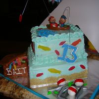 Dscn3400.jpg 10 and 8 inch square cakes covered in blue vanilla buttercream. the bait box is made out of rice krispy treats and covered in fondant, the...