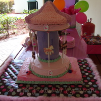 Carousel Cake the very top is rice krispy treats, everything else is cake. with chocolate horses. strawberry-vanilla marbled cake with swiss buttercream...