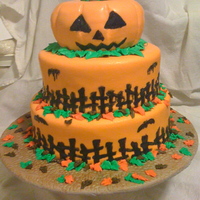 Halloween Cake 3 Tiered fondant covered cake. Bats and fence are royal icing. Unfortunately the RI bled afterwards. :( The leaves are buttercream. Overall...