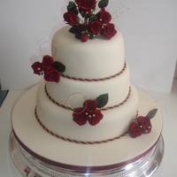 Roses Wedding Cake 3 tier round wedding cake with hand made red rose posy's. All flowers hand made using flower/petal paste, colouring, dust and steamed...