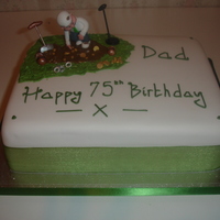 Metal Detecting Dad Oblong sponge cake covered in sugarpaste decorated with a plastic man who is digging in the mud for treasure!