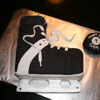 Hockey Skate White cake covered with fondant. Laces and blade are made of fondant also. Blade is painted silver.
