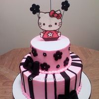 Hello Kitty WASC frosted in buttercream and decorated with fondant accents and a chocolate transfer.