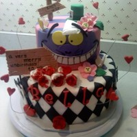 Alice In Wonderland White Cake with Vanilla Buttercream filling. Top tier: Cheshire Cat, Bottom tier: Queen of Hearts theme