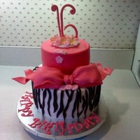 Zebra Sweet Sixteen First time doing zebra stripes. Happy with the colors and the accessories. White cake with chocolate mousse filling.