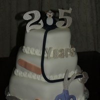 Doctor's Anniversary A doctor friend of mine asked me to make her a 25th anniversary cake celebrating 25 years of her practice. The bottom layer is dark...