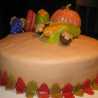 Harvest Cake Gingerbread cake covered in MMF (marshmallow fondant). Sculpted veggies made with rice krispie treats (RKT)