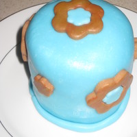 First Cake With Mmf First time covering a cake with MMF. Cake from a sheet cake, cut with a 3" round cookie cutter. Yellow Butter cake with Blue and Brown...