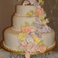 Pastel Wedding Cake The cake is covered in fondant and sugar flowers