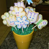 My First Cookie Bouquet My first venture into cookies. I made this for my son's 3rd grade teacher. They are NFSC, decorated with fondant and royal tube icing...