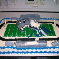 Homecoming Cake Miniature version of the football stadium with the school mascot and school colors on the field. Bulldog and ribbons made of fondant; mum...