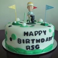 Mr. Bobble-Head Golfer This is a 10-inch cake with a bobbly headed golfer (made of wax). there are also plastic golf tees (is that correct) and "grass...