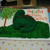 Dino Cake Cake was made for my son's 3rd birthday. I used a Wilton dino pan and placed in on top of another cake. The tree is made with pretzel...