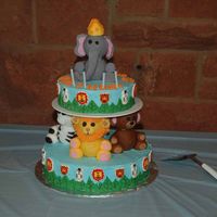Zoo Cake This cake was done for my son's birthday that we had a the zoo. The animals are done in rolled fondant.