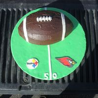 Super Bowl Cake WASC cake filled and iced with ganache. fondant accents. took the pic on the tailgate of DH truck...thought it was appropriate for football...