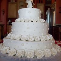Carcar's Wedding Cake This was my first wedding cake. It was a strawberry cake with buttercream icing and royal icing dots. The flowers were gum paste.