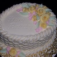 Birthday Cake I made this for a friend at work. I wanted to try out the Duff roses. She loved it! It was chocolate fudge cake with buttercream frosting...