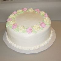 L Small Wedding Cake This is a 10" round done for a lady having a small garden wedding. Spice cake with buttercream icing and roses.