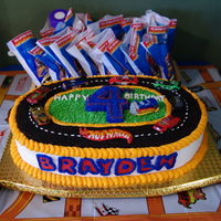 Hot Wheels Party Cake Cake is 2 - 12" layers, split & 2 - 9x13" layers trimmed to form oval track. "Asphalt" is made from chocolate...
