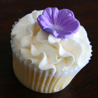 Purple Flower Wedding Cupcakes A cupcake with buttercream icing frilly swirl and topped with a vivid purple embossed flower! Thanks for looking...