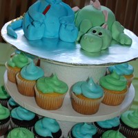 Dinosaur Party cupcake size cakes stacked and carved... covered in fondant. heads, legs and tails in fondant :D