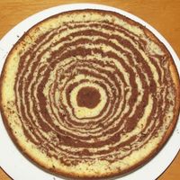 Sponge Cut Into Halves-Marble Effect Mady by stacking cake batter upon itself onthe centre of the pan, allowing the weight of the batter to spread the batter out in the pan.