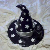 Witch/wizard Hat W/ Kitty Cat Pumpkin Spice Cake w/ cream cheese frosting. Sculpted cake in shape of hat. Covered in MMF. Cat is made of rice krispy treats and covered...