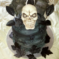 Skull/graveyard Cake Lat minute cake I whipped up for a same day event. Pumpkin Cake with Chocolate cake - Rum Buttercream filling. Cake iced in buttercream.