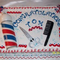 Barber Retirement Barber pole made from gumpaste as well as the scissors & comb.