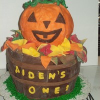 Aiden's 1St Birthday This is a pumpkin spice cake with chi latte icing. It is covered in modeling chocolate as are all of the decorations are out of modeling...