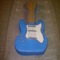 Guitar Cake This was my first guitar cake. I just used a 9x13 pan & shaped my guitar. Cake was chocolate covered in buttercream w/fondant accents...