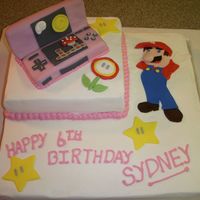 Mario Birthday Cake Made for 6 yr. old girl who has a Pink Nintendo DS & loves Mario. Cake is White Almond Sour Cream with fondant accents.