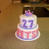Pink & Purple Birthday Cake Choclate cake w/bc icing & fondant accents.