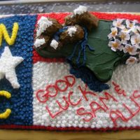 Leaving For North Carolina This cake was inspired by North Carolina, the couple was moving there. Incoporated the state flag and start flower (dogwood).
