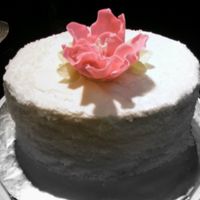 Fantasy_Flower.jpg Put together in hurry, Sugar on sides and large fantasy flower in center. Oval cake.