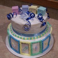 Baby Shower Cake Made of buttercream with real ribbon and decorative objects.