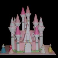 Princess Castle buttercream with fondant flowers and turrets. you can see i had 2 sleeping beauty dolls and no cinderella, so i covered one dress in blue...